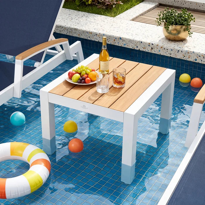 Peak Home Furnishings modern outdoor end table with waterproof white aluminum frame placed inside a swimming pool with drinks.